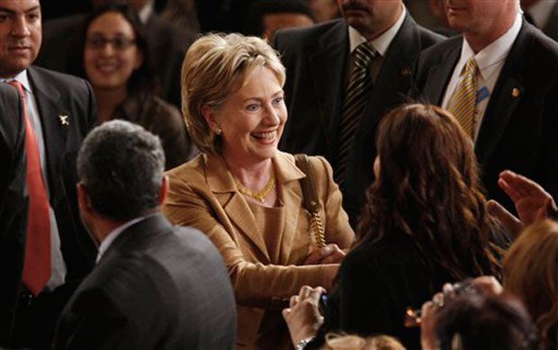 Secretary of State Hillary Clinton greets people before the speech.